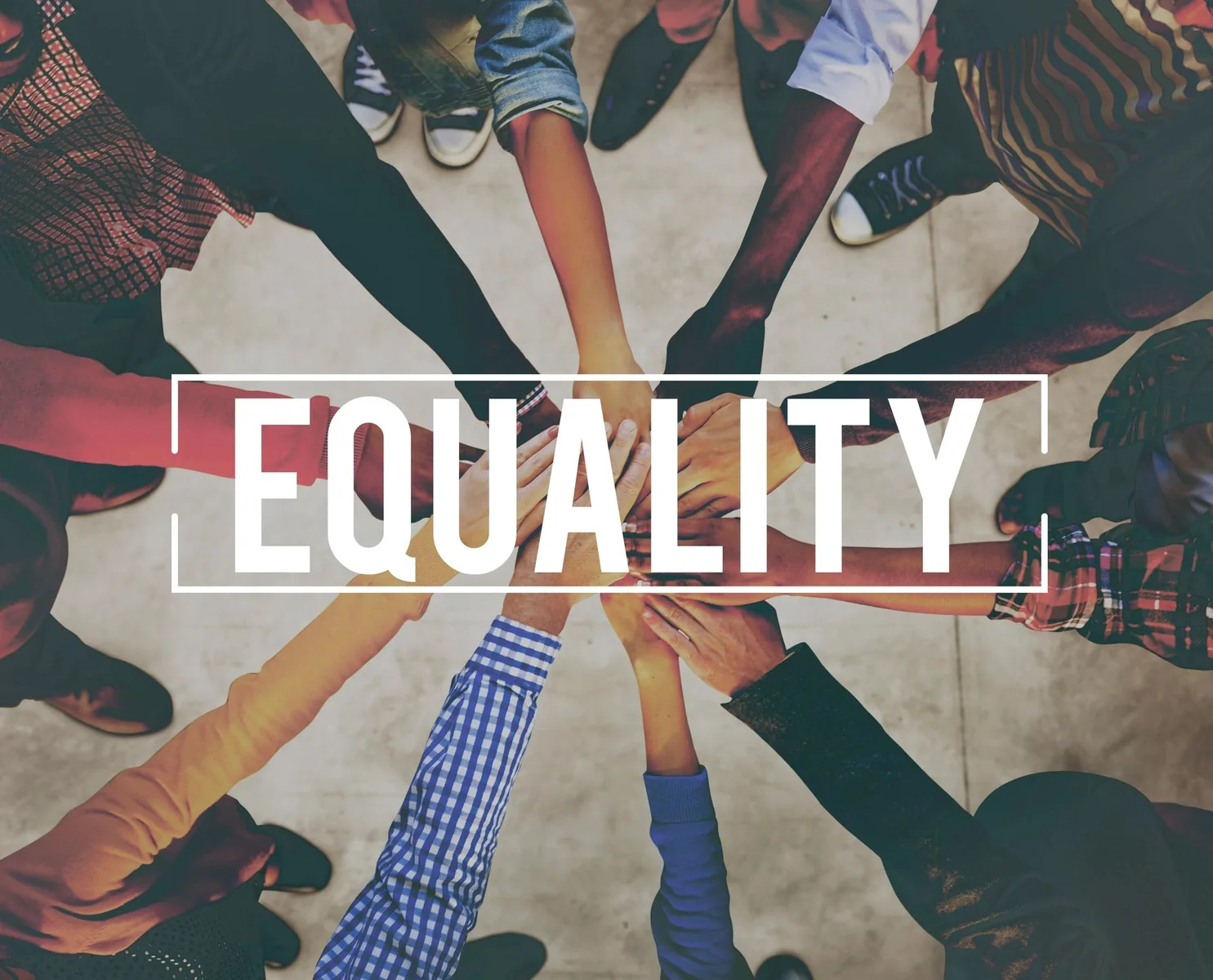 A diverse group joins hands around the word Equality.