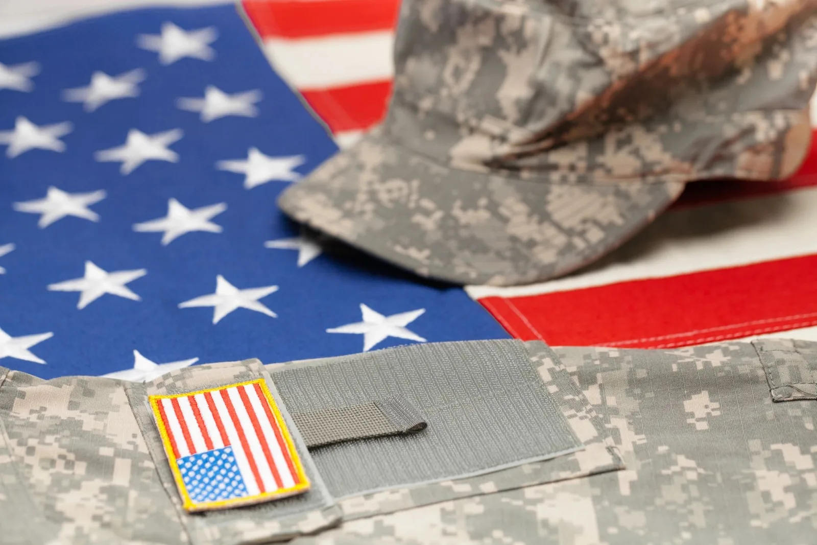 United States flag with military uniforms and service ribbon.